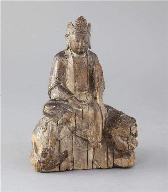 An early Chinese wood group of Wenshu or Manjushri, Song/Yuan dynasty, height 21cm, later stand